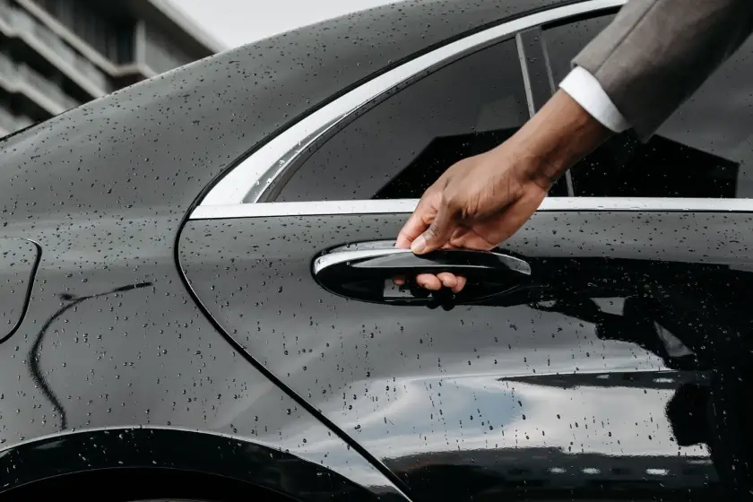 nice airport transfer 2 Private chauffeur opening the door of a black Mercedes saloon